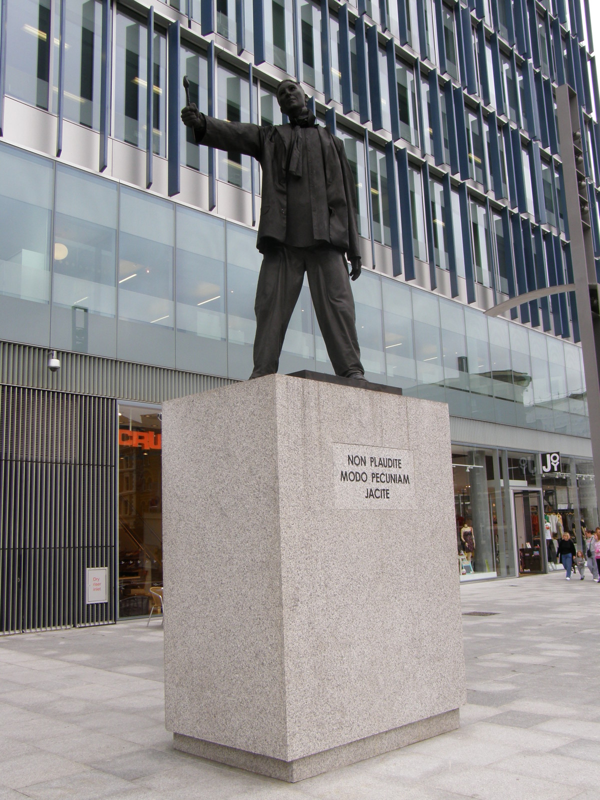 The statue outside the Blue Fin Building: 'Don't applaud, just throw money'