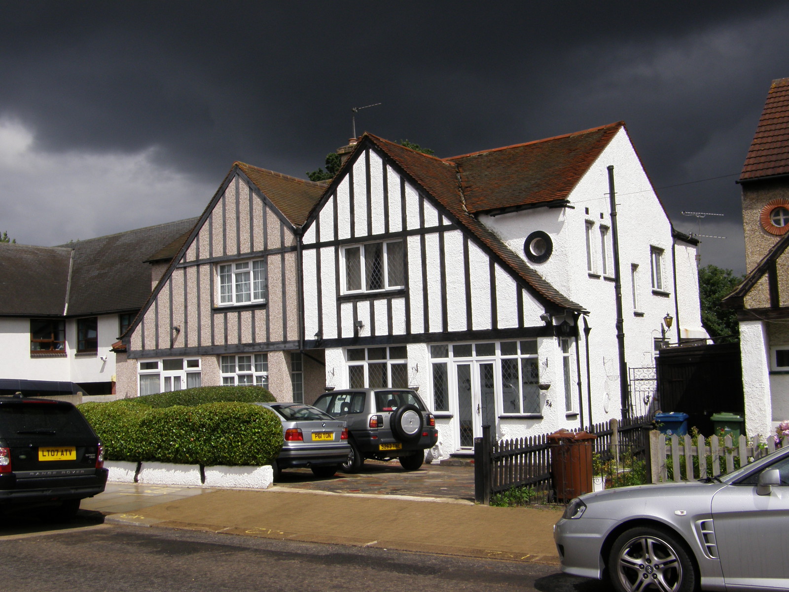 Storm clouds and Mock Tudor houses