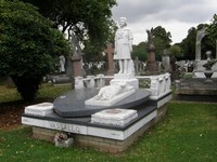 A memorial to a lady with a handbag in East London Cemetery
