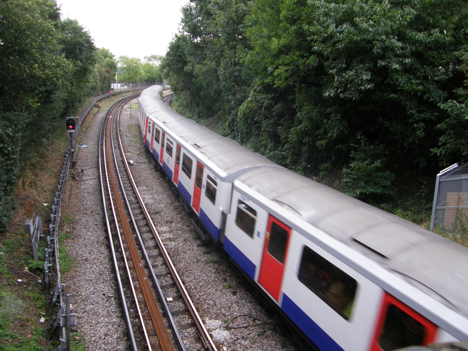 A District Line train travelling between Ealing Broadway and Ealing Common